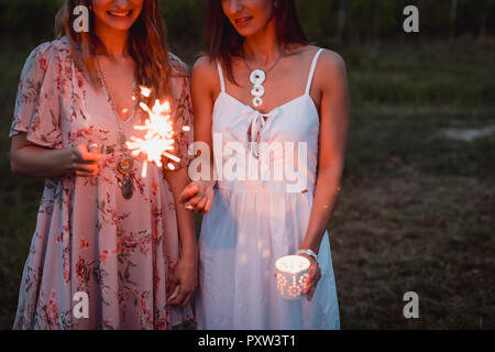 Friends having a picnic in a vinyard, burning sparklers Stock Photo