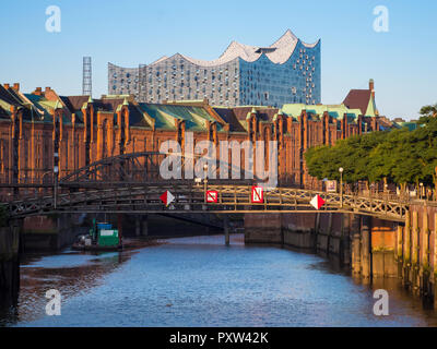 Germany, Hamburg, Old warehouse district at Zollkanal with Elbe philharmonic hall in background Stock Photo