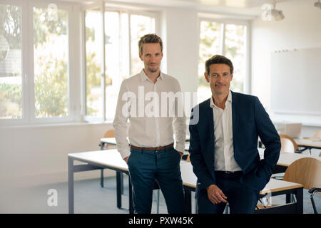 Businessmen sitting in conference room Stock Photo