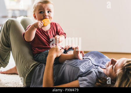 Mother and son at home eating ice lolly Stock Photo