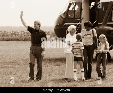 President Jimmy Carter disembarks Marine One - arriving in Plains, GA. With the President is his mother, Lillian Carter, daughter Amy accompanied by her nanny, Mary Prince. Ms. Prince, a black woman, -once convicted of murder in Georgia - was assigned to work as a trustee at the Georgia governor's mansion in a work-release program. Governor Carter became acquainted with Ms. Prince and was firmly convinced that she was innocent of the murder charge. Carter later applied to be Ms. Princes' parole officer so that she could come to the White House to become Amy's nanny. Later, Prince was pardoned  Stock Photo