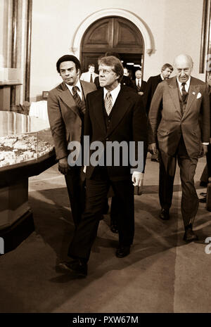 President Jimmy Carter flanked by his Ambassador to the United Nations, Andrew J. Young (left), walk into a meeting at The Smithsonian Institution's Castle building. 1978 Stock Photo