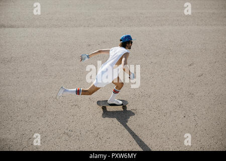 From above shot of sportive man skateboarding Stock Photo