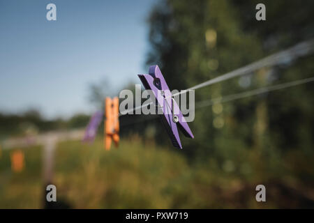 Clothes pegs hanging on washing line Stock Photo