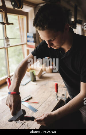 Carpenter working on piece of wood in workshop Stock Photo