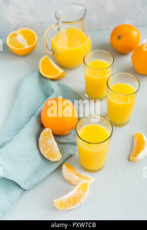 Glasses of freshly squeezed orange juice and oranges Stock Photo