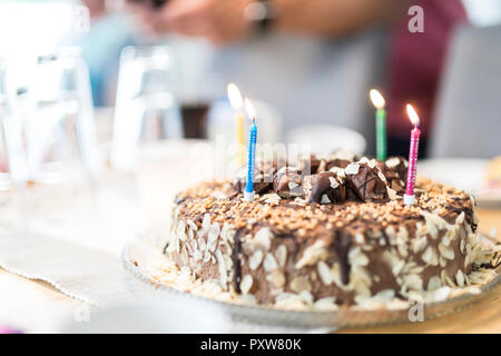 Lighted birthday candles on a cake Stock Photo
