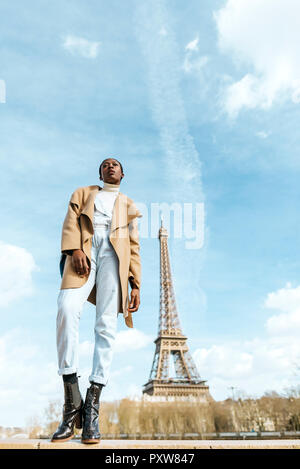 France, Paris, Woman posing with the Eiffel tower in the background Stock Photo