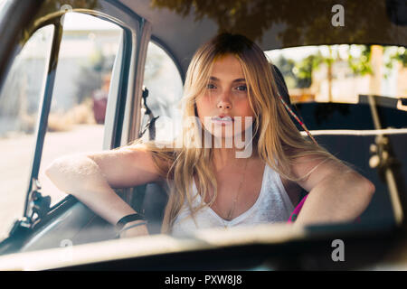 Portrait of young woman sitting in a car Stock Photo