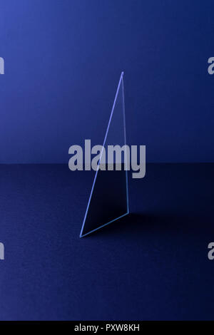 Triangle shaped mirror on dark blue ground, 3D Rendering Stock Photo