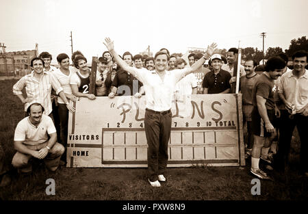 A post softball game photo of a team of off duty US Secret Service agents is upstaged by a red clay stained Vice President Walter Mondale as he jumped into the middle of the team photo at the Plains, Georgia High School baseball field in 1977. The Secret Service agents played on President Jimmy Carter's team that played against a team made up by members of the White House traveling press. - To license this image, click on the shopping cart below - Stock Photo