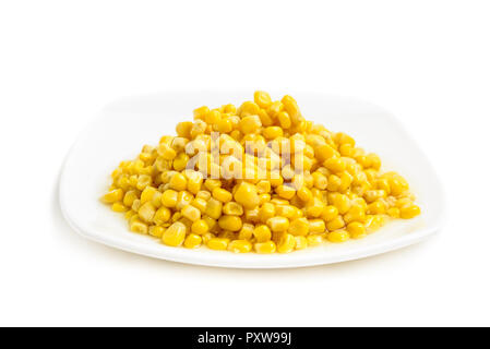 Corn on white plate isolated. Side view Stock Photo