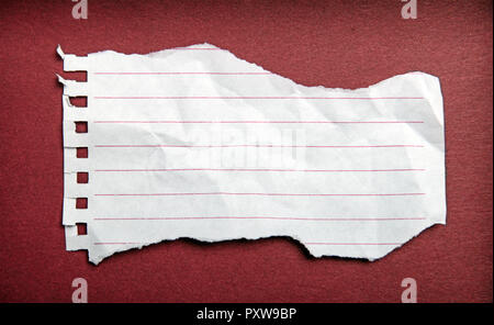 Turn notebook paper on dark red background Stock Photo