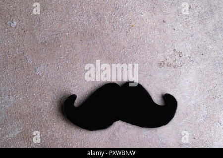 mustache black on a stick isolated on grey background, Mens day, Father day Stock Photo