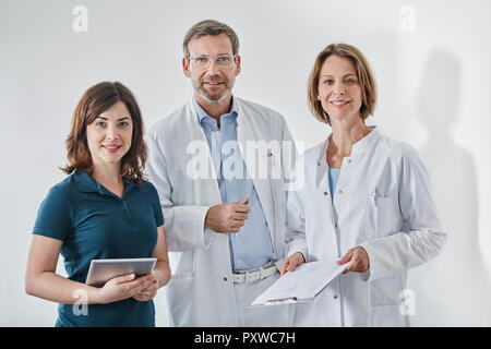 Doctors and medical secretary with tablet Stock Photo