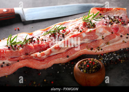 Raw ribs with spices on a stone background with empty space for text Stock Photo