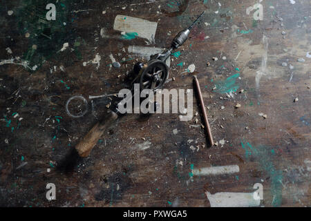 Old hand drill and pencil in workshop Stock Photo