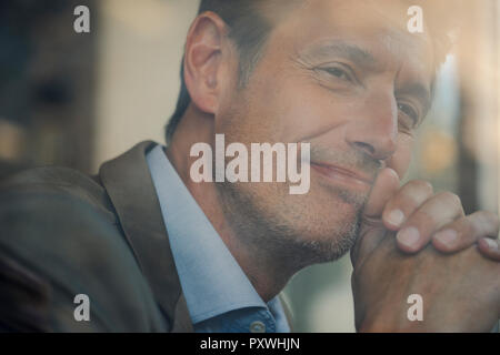 Mature businessman sitting in coffee shop, portrait Stock Photo