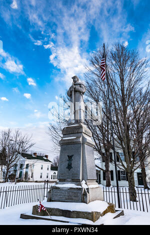 Marble monument to soldiers who fought in the Civil War covered in snow, with American flag. Stock Photo