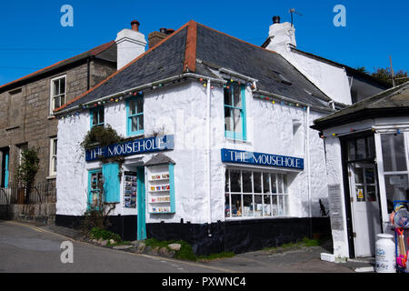 World famous white painted, bow windowed, picturesque, old corner shop called 'The Mousehole' on a hill and near the harbour of Mousehole Stock Photo