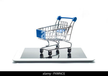 Empty metal shopping cart on a digital tablet or smartphone isolated on white background. Concept image for e-commerce and online shopping Stock Photo