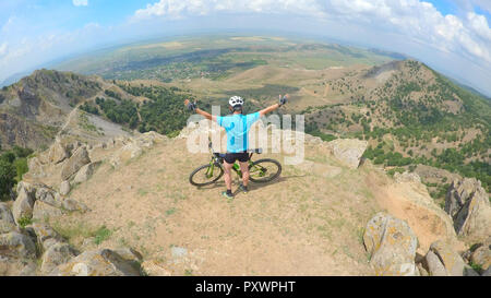 Biker feeling free in the top of mountains Stock Photo
