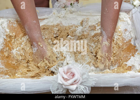 Female hands are kneading dough for traditional dishes. Stock Photo