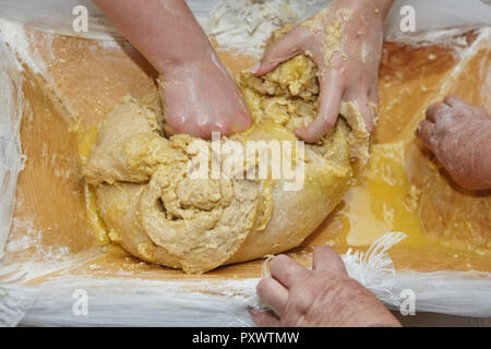 Female hands are kneading dough for traditional dishes. Stock Photo