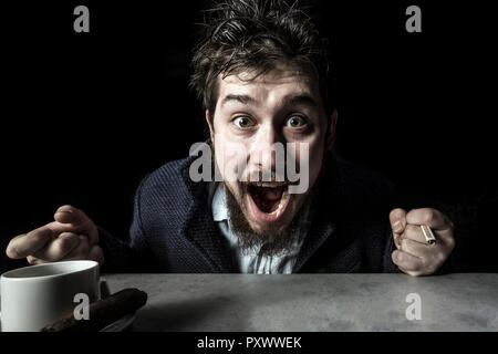 portrait of emotionally shocked by success guy on a black background, concept of winning Stock Photo