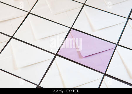 Composition with white and purple envelopes on the table. Different colored envelopes on the table. Stock Photo