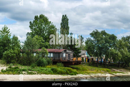 Old rusty fishing boat ship on the bank of the Pripyat River in the city of Petrikov. Belarus Stock Photo