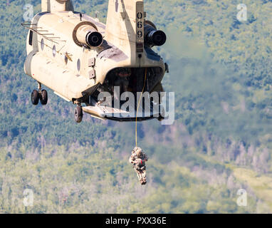 Soldier jumping out of a Chinook at Leapfest 2018, an international static line parachute training event and competition. Stock Photo