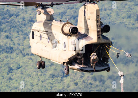 Soldier jumping out of a Chinook at Leapfest 2018, an international static line parachute training event and competition. Stock Photo