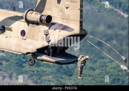 Soldier jumping out of a Chinook at Leapfest 2018, an international static line parachute training event and competition. Stock Photo