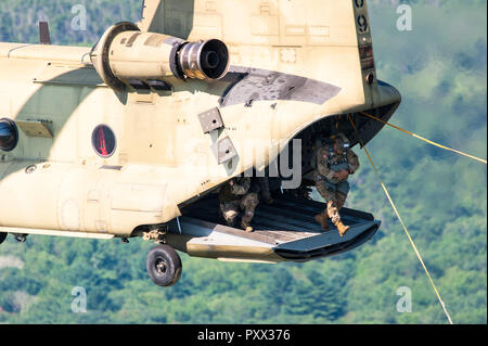 Soldier jumping out of a Chinook at Leapfest 2018, an international static line parachute training event and competition. Stock Photo