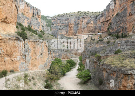 The Our Lady of Jaraba Sanctuary in the Barranco de la Hoz Seca canyon (Dry Defile Gully) in the Aragon region, Spain, during a sunny summer day Stock Photo