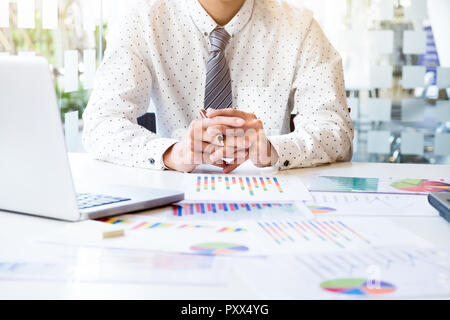 Startup businessman working with business documents on office table with graph financial diagram. Business idea concept. Stock Photo