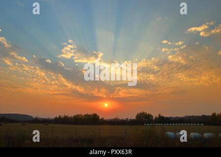 Sun rays over sky at sunset Stock Photo
