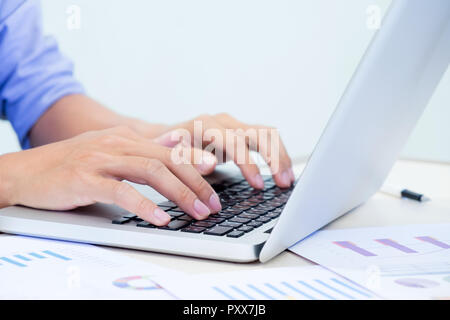 Man's hands typing on laptop keyboard Stock Photo