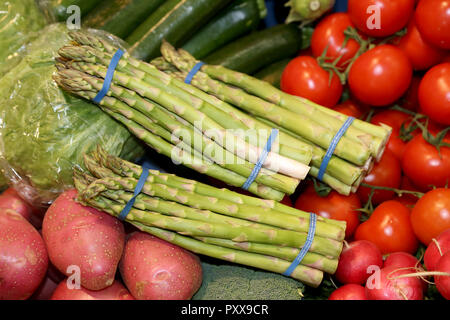 Background from freshly picked asparagus sparrow grass and tomatoes Stock Photo