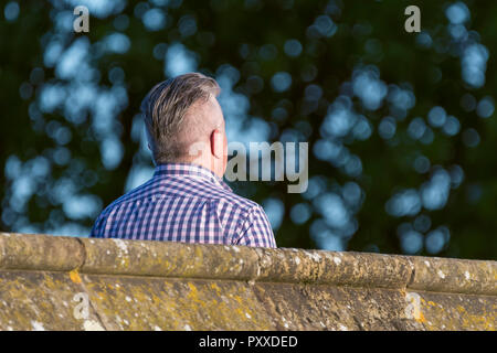 Man walking across a bridge. Stock Photo