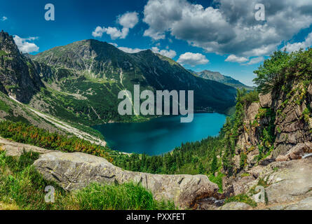 View on the turquoise color lake between high and rocky mountains. Beautiful alpine landscape. Stock Photo