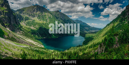 View on the turquoise color lake between high and rocky mountains. Beautiful alpine landscape. Stock Photo