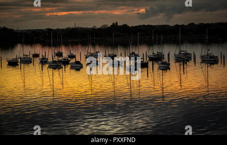 Boats moored in Portsmouth Harbour at sunset Stock Photo