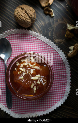 Sweet quince jam in glass dish with  quinces  on wooden background Stock Photo