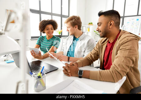 creative team discussing papers at office Stock Photo