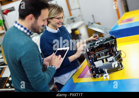 Young attractive students of mechatronics working on project Stock Photo