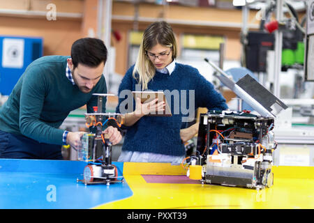 Young attractive students of mechatronics working on project Stock Photo
