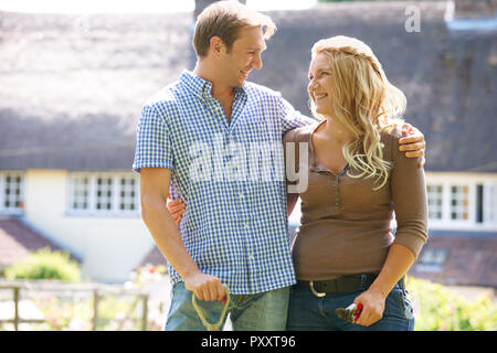 Young Couple At Home Working In Garden Together Stock Photo