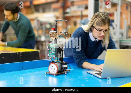 Young woman engineer working on robotics project Stock Photo